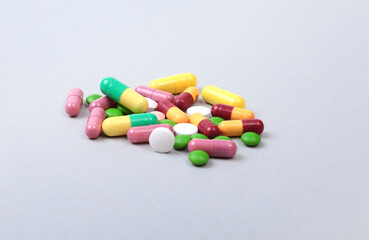Assorted pills isolated on white background. Selective focus.