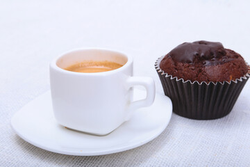 Fresh homemade muffin, cake and white cup of Cappuccino on white background.