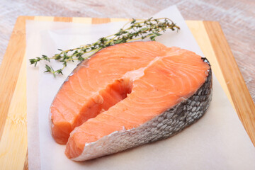 fresh raw salmon with spices on wooden cutting board. ready for cookin