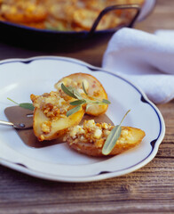 Baked potato wedges with walnut and goat cheese