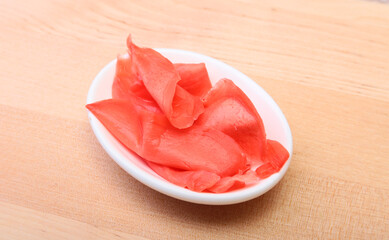 plate with Japanese pickled ginge on wood background.