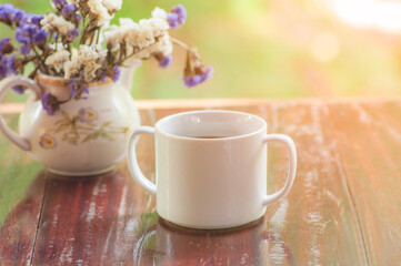 Morning coffee cup with flowers in jar, start up concept