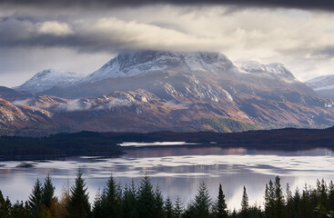 The summits of Slioch and Beinn a Mhuinidh over Loch Maree in the Scottish Highlands, Scotland, UK.