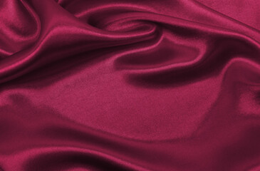 Smooth elegant pink silk or satin luxury cloth texture as abstract background. Luxurious background design