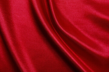 Smooth elegant red silk or satin luxury cloth texture as abstract background. Luxurious background design