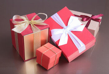 red and gold gift box on wood background.