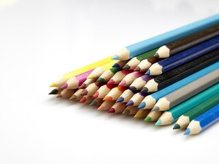 Many different colored pencils on white background