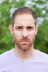 Portrait of a casual bearded man in a park