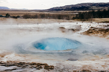 .Natural landscape of the blast process of a Geyser in Iceland.