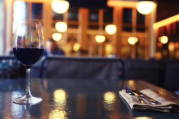 Serving a glass of red wine in a restaurant