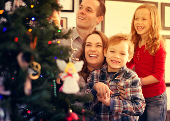 Happy family of four preparing for Christmas