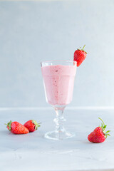 Fresh and Cold Strawberry Smoothie in Tall Glasses on Grey Background 