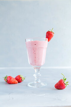 Fresh and Cold Strawberry Smoothie in Tall Glasses on Grey Background 