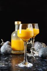 Traditional Italian yellow egg liquor, Bombardino. Dark background. Copy space.