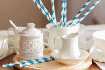 Set of white empty tableware with striped tubules