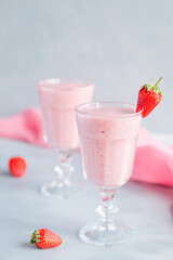Fresh and Cold Strawberry Smoothie in Tall Glasses on Grey Background 