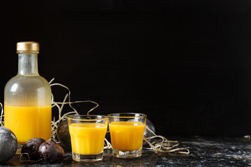 Traditional Italian yellow egg liquor, Bombardino. Dark background. Copy space.