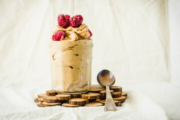 Healthy chocolate banana ice cream, raspberries in a glass jar