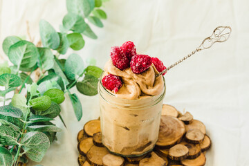 Healthy chocolate banana ice cream, raspberries in a glass jar