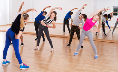 Fototapeta na wymiar Teenagers stretching in dance hall
