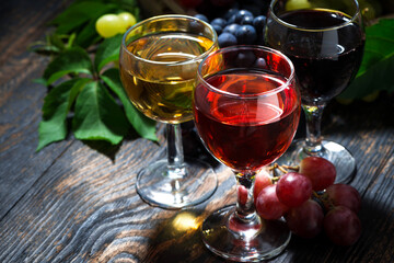assortment different wine on dark wooden background, top view