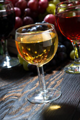assortment different wine on dark wooden table, vertical, closeup