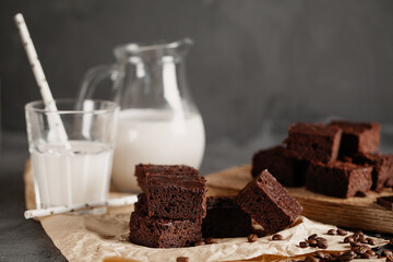 Brownie with milk on a dark background