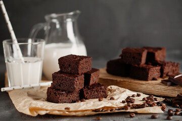Brownie with milk on a dark background
