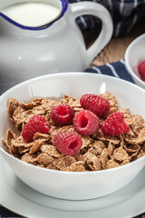 Tasty breakfast with milk and raspberries.