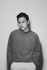 Fototapeta premium Young asian man's portrait against black background