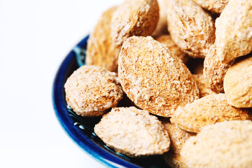 Roasted salted almond nuts in nutshell