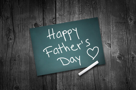 Happy fathers day sign on wooden boards background