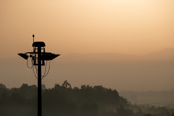 Spotlight pole with mountain in the background