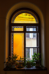 Fototapeta na wymiar Old window in the stairwell with stained glass
