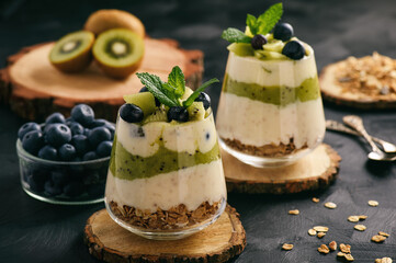 Healthy food -layered dessert with yogurt, muesli, kiwi and blueberry.