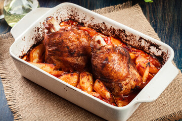 Roasted turkey knuckle with potatoes and vegetable