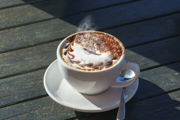 Hot Caffè mocha or mocaccino on wooden table