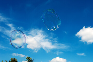 Soap bubbles. Bubbles in the blue sky. Giant bubbles