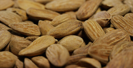 Close-up of light brown almonds. Concept: salted, nuts, seeds, tasty, healthy, fresh product, shrub or small tree from the subgenus Almonds of the genus Plum, proper nutrition and energy.
