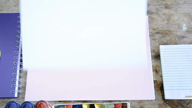 woman opening blank page of many color paper(presentation concept)