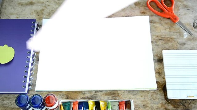 woman opening blank page of many color paper (presentation concept)