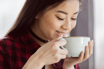 attractive asian girl drinking coffee in cafe, coffee break concept