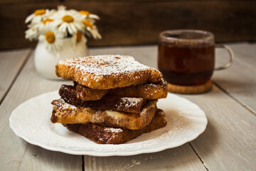 french toast with tea on wooden background