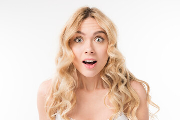 portrait of beautiful excited girl with blond curly hair isolated on white in studio