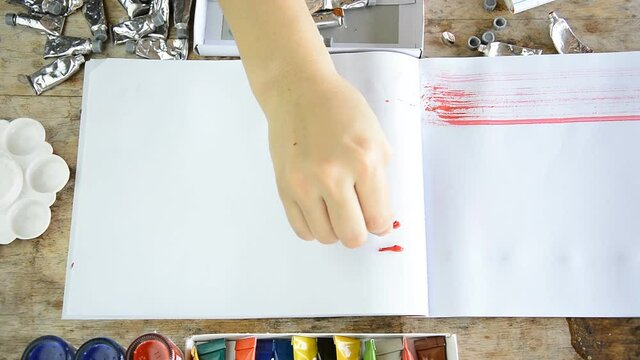 Woman painting stoke with color for your presentation or text on notebook  (presentation concept)