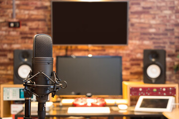 condenser microphone on digital recording studio background