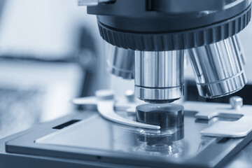 The microscope in light blue scene.Laboratory equipment concept.
