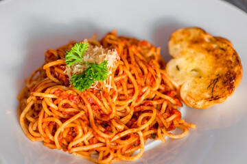 Close-up of a traditional spaghetti bolognese on a white plate