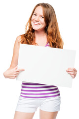 Fototapeta premium Young red-haired girl showing a blank white banner