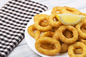 Close-up of squid dish to roman on wooden table. Squids.
